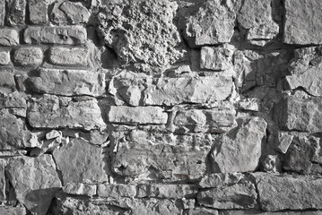 gray background.wall of stones and bricks