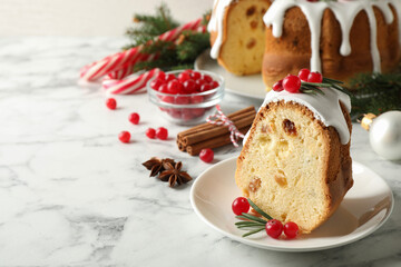 Composition with piece of traditional homemade Christmas cake on white marble table, closeup. Space for text