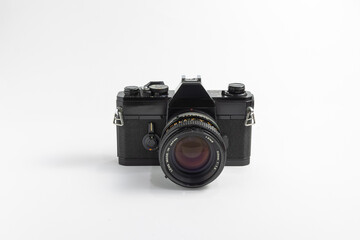 Classic vintage black film SLR camera with 50mm lens attached isolated in white background. 