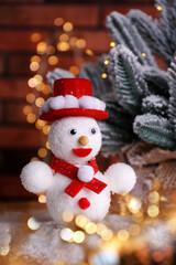 Cute snowman and Christmas decoration, bokeh effect