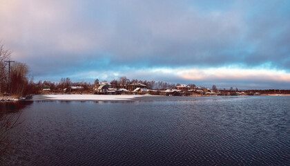 Panoramic winter view with old houses near a snow-covered lake. Authentic Northern city of Kem in winter. Russia © sablinstanislav