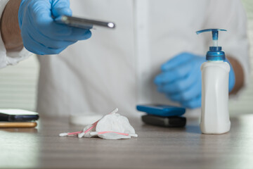 Closeup of man giving mobile phone after sanitazing, sanitizing devices through which the virus is transmitted