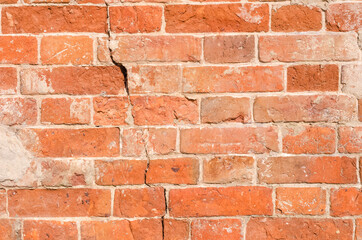 Texture background of old brick wall with crack