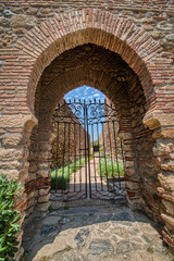 Arab architectural style door located in the Alcazaba, a palatial fortification from the Islamic period of the 11th century built in Malaga, Costa del Sol, Andalusia, Spain.