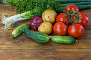 Close up view of colorful vegetables on brown wooden background isolated.