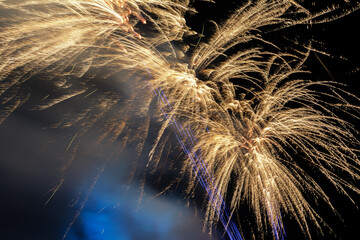 Happy New Year and Merry Christmas. Gold and dark blue Fireworks.
Holiday fireworks on dark background. 