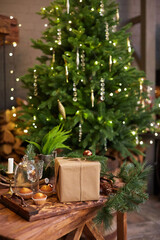 Home Christmas decoration interior late in night with light on xmas tree and gifts.