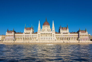 Fototapeta premium Hungarian National Parliament Building on the bank of the Danube river in Budapest, capital of Hungary. Hungarian landmark and a popular tourist destination in Budapest. Designed in neo-Gothic style