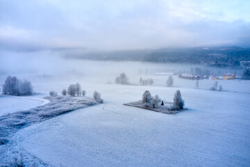 Winter Landscape with a feeling of christmas. Drone photo from the Norway. It's cold and snow is coming. 