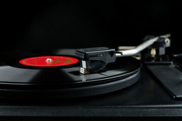 vinyl record on a turntable. turntable head close-up on black background with copy space