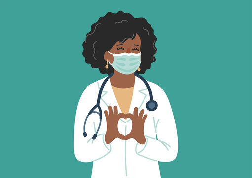 African-american doctor in medical mask makes heart shape. Female physician love with her job.