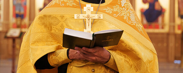 Orthodox Church. Christianity. Priest hands holding Holy Bible book in traditional Orthodox Church...