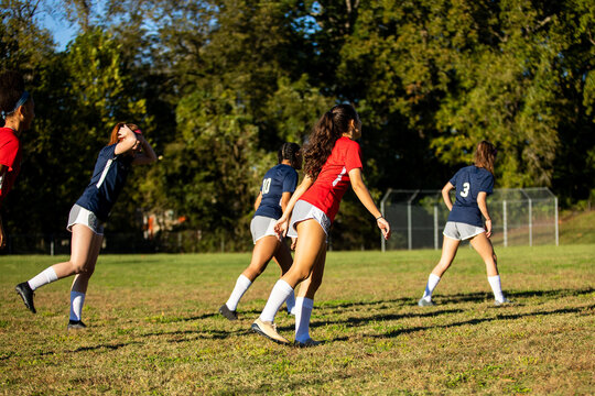 Girl soccer team stretches and warm up for scrimmage game