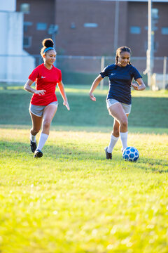 Fototapeta Teenage girl soccer players running after ball