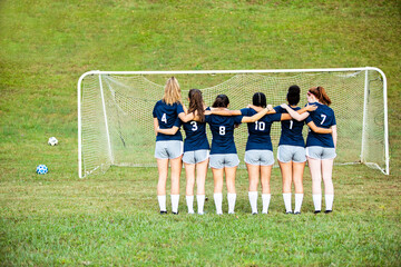 Teammate togetherness portraits on soccer field