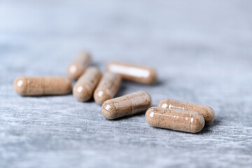 Ashwagandha  (Withania somnifera) capsules.  Bright wooden background. Close up. 