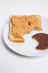 Slice of bread and chocolate biscuit on plate