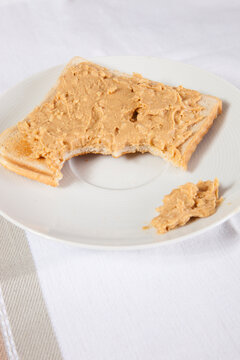 Peanut Butter On Slice Of Bitten Bread