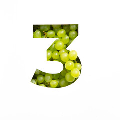 Number three made of green grape and paper cut in shape of third numeral isolated on white. Natural...