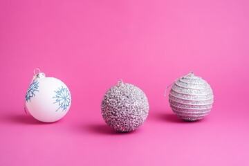 Christmas New Year composition. Gifts, silver and white ball decorations on pink background. Winter holidays concept. Angle view