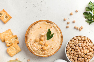 Flatlay hummus in a wooden plate, chickpeas, croutons. Dishes of chickpeas, a vegetarian dish. Copy...