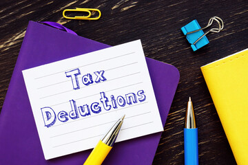 Financial concept about Tax Deductions with phrase on the sheet.