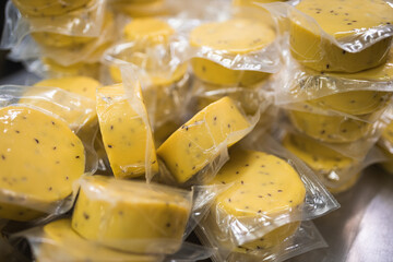 cheese with cumin seeds in package yellow  vacuum sealed 