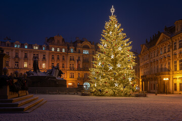Christmas tree and the Old Town Square in Prague, Czech Republic, covered by fresh snow. No...
