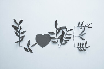 black and white photo, the word "Love" written from bush branches on a white background