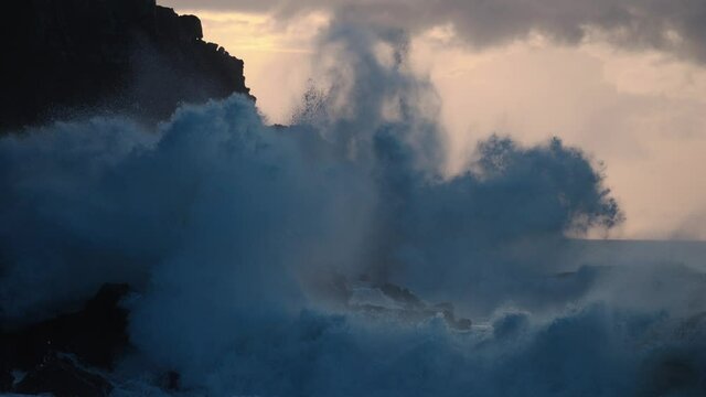 Extreme slow motion of beautiful ocean waves crashing into Kaiaka Rock, Molokai Hawaii suggests refreshment, beauty, inspiration, water, power, environmentalism and nature.