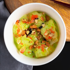 Shrimps in sweet wasabi mayo sauce. Vasabi prawns in green spicy dish. Asian china or thai crunch seafood, top view, dark black table. Square image for post.