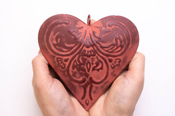 Fototapeta premium female palms holding a red iron heart