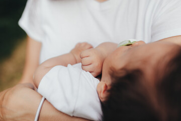 Fototapeta premium Little baby's hands, mother with baby, care of baby, mother carrying baby