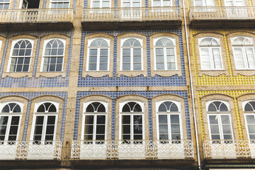 facade of a building in Portugal Guimar&atilde;es ajulejos colorful blue yellow  windows 