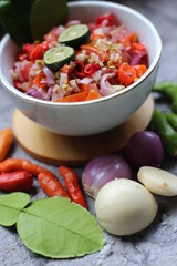 Sambal Jeruk Nipis Or Spicy Lime Sauce with ingredients, Lime, Red Chilies, Green Chilies, garlic, and salt. 