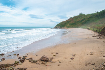 Misty beach on the Northern coast of Spain in Asturias on an overcast day.