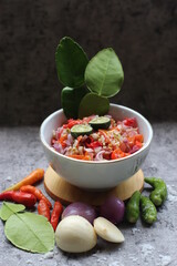 Sambal Jeruk Nipis Or Spicy Lime Sauce with ingredients, Lime, Red Chilies, Green Chilies, garlic, and salt. 