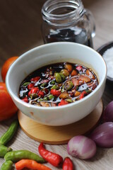 Sambal Kecap Or Hot soy sauce,  with ingredients, soy sauce, chilies,  garlic, salt, and tomatoes