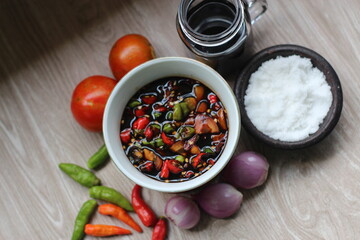 Sambal Kecap Or Hot soy sauce,  with ingredients, soy sauce, chilies,  garlic, salt, and tomatoes
