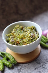Sambal ijo Or Green chili sauce with ingredients, Greem chilies, onion, garlic, and salt 