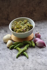 Sambal ijo Or Green chili sauce with ingredients, Greem chilies, onion, garlic, and salt 