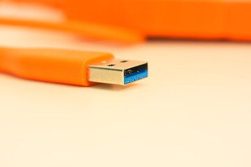 Orange hard drive for information storage and USB close-up port