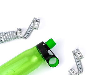 Sports water bottle and centimeter on a white background. The concept of fitness, sports.