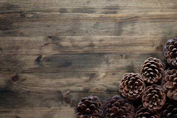 Pinecones on wood stained table for copy