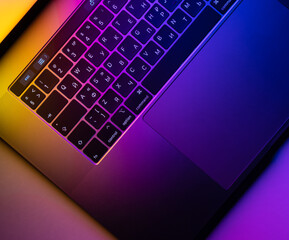MacBook Pro keyboard illuminated by gradient