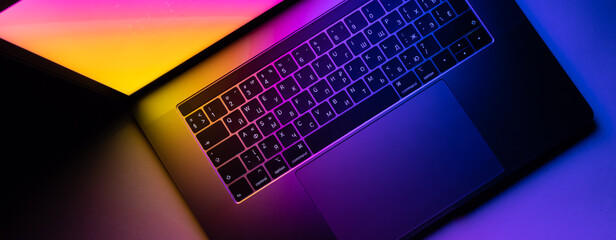 MacBook Pro keyboard illuminated by gradient - obrazy, fototapety, plakaty