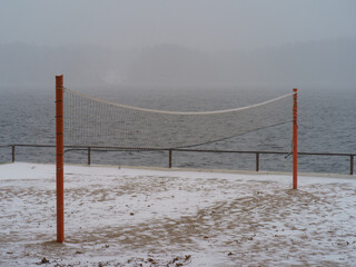 Blizzard in the touristic resort. Snowy Russian winter coming. River bank had been covered by snow....