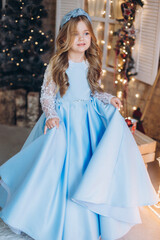 Obraz na płótnie Canvas Little cute happy adorable girl in elegant fashion dress in christmas decorations. Christmas holidays, celebaration concept