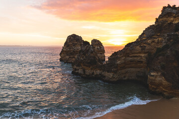 Praia da Boneca do Camilo Lagos Portugal beach water ocean Atlantic rock formations hills morning sunrise violet sky coast sand waves 