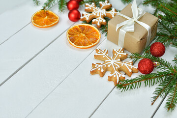 christmas background with spices, dried oranges , fir tree and gingerbread cookies.Festive Winter Holidays concept.Copy space for text.